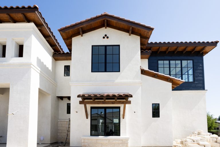 Outside shot of masonry work being completed, windows and roof work completed.